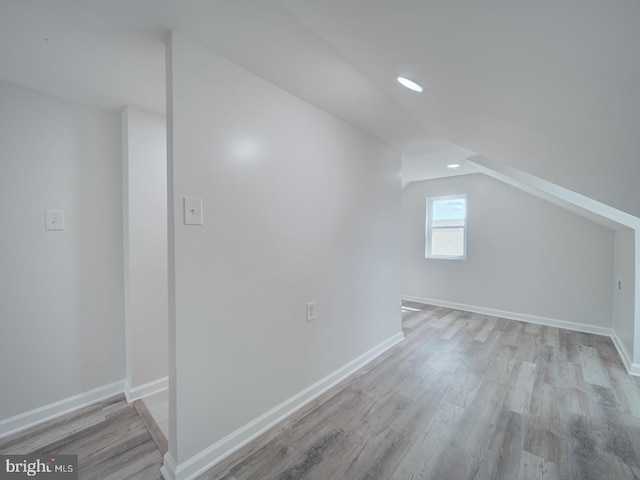bonus room featuring recessed lighting, vaulted ceiling, wood finished floors, and baseboards