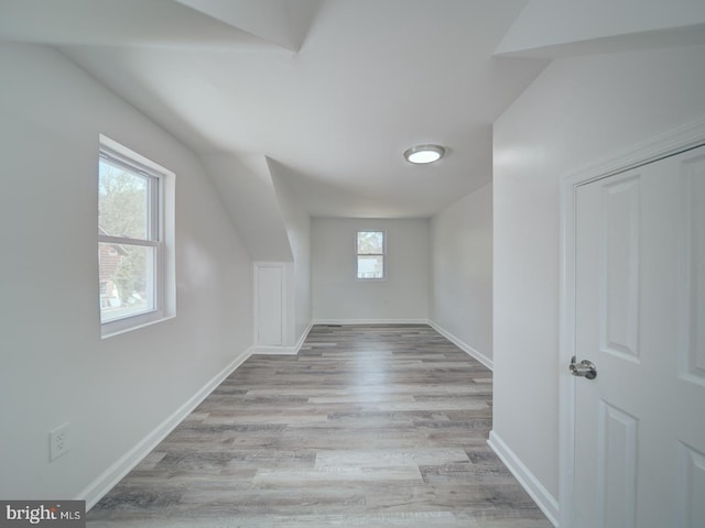 additional living space with light wood-type flooring and baseboards