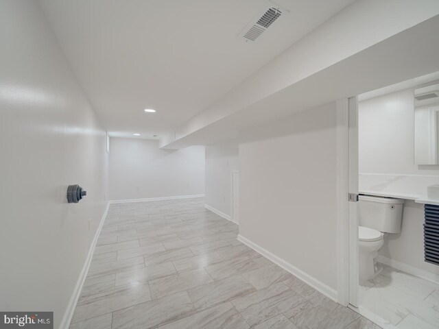 interior space with recessed lighting, marble finish floor, visible vents, toilet, and baseboards