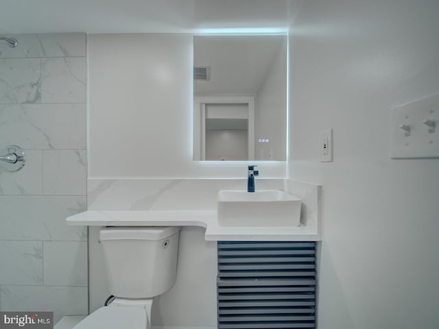 bathroom with visible vents, vanity, and toilet