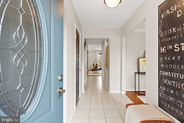 foyer featuring tile patterned floors and baseboards