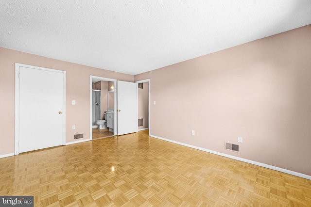 21 Fisher Dr, Franklin Park, NJ 08823 - unfurnished bedroom featuring baseboards, connected bathroom, and a textured ceiling