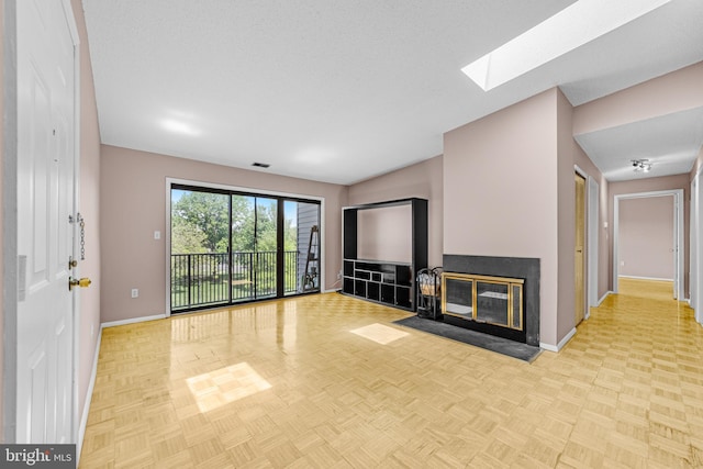 21 Fisher Dr, Franklin Park, NJ 08823 - unfurnished living room with baseboards, a skylight, and a multi sided fireplace
