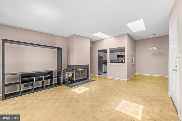 21 Fisher Dr, Franklin Park, NJ 08823 - unfurnished living room featuring a skylight, baseboards, and a multi sided fireplace