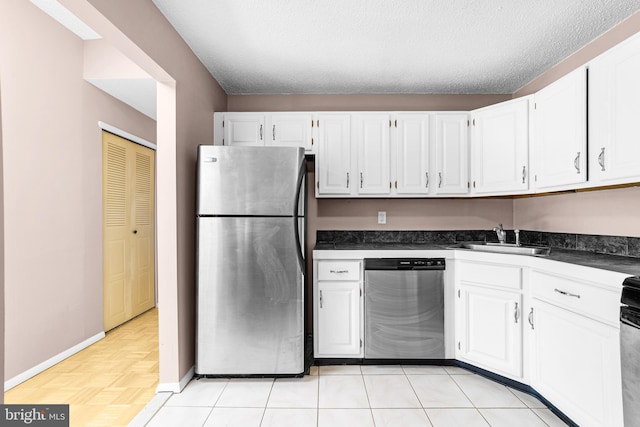21 Fisher Dr, Franklin Park, NJ 08823 - kitchen featuring appliances with stainless steel finishes, a sink, dark countertops, white cabinets, and baseboards