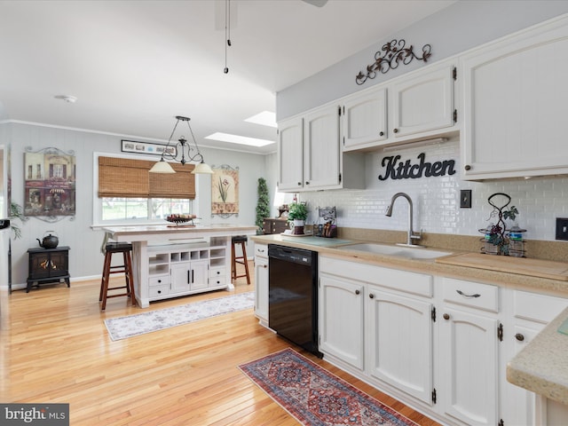 504 S Church St, Charles Town, WV 25414 - kitchen with backsplash, light wood-style floors, black dishwasher, and a sink