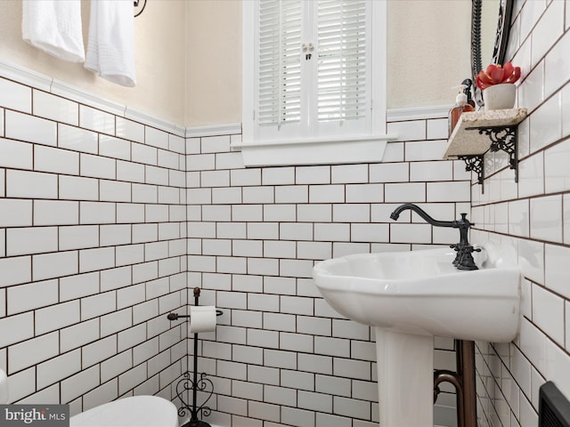 504 S Church St, Charles Town, WV 25414 - bathroom featuring tile walls, toilet, and a wainscoted wall
