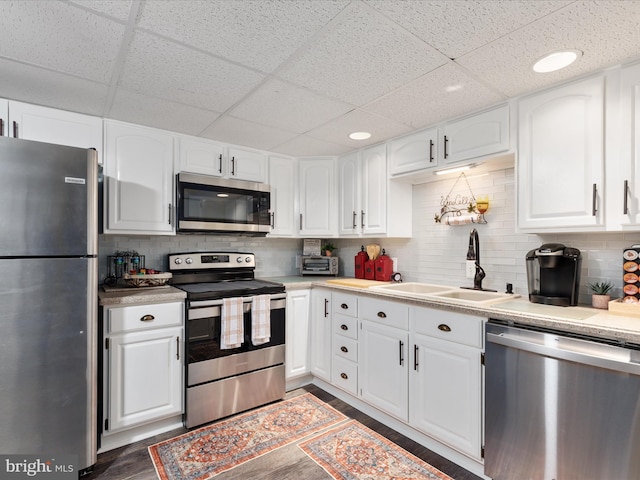 504 S Church St, Charles Town, WV 25414 - kitchen featuring white cabinets, light countertops, wood finished floors, a sink, and appliances with stainless steel finishes