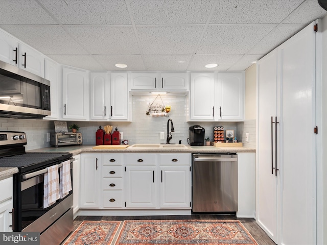 504 S Church St, Charles Town, WV 25414 - kitchen with dark wood finished floors, a drop ceiling, stainless steel appliances, backsplash, and a sink