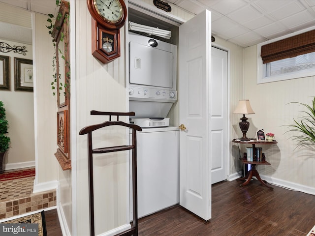 504 S Church St, Charles Town, WV 25414 - clothes washing area featuring dark wood-style floors, baseboards, stacked washer / drying machine, and laundry area