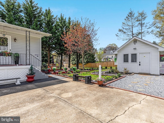 504 S Church St, Charles Town, WV 25414 - view of patio with a garden, fence, an outbuilding, and covered porch