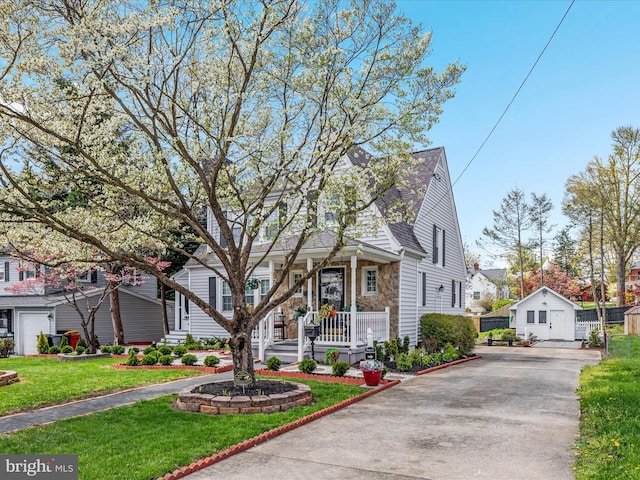 504 S Church St, Charles Town, WV 25414 - bungalow-style home featuring a front lawn, a residential view, driveway, stone siding, and a porch