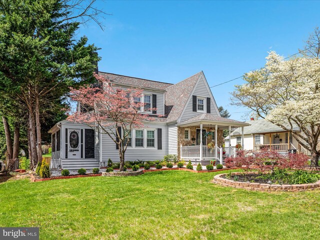 504 S Church St, Charles Town, WV 25414 - view of front facade featuring a porch, roof with shingles, and a front yard
