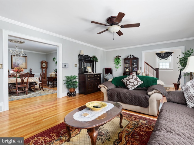 504 S Church St, Charles Town, WV 25414 - living area with light wood-type flooring, crown molding, baseboards, and ceiling fan with notable chandelier