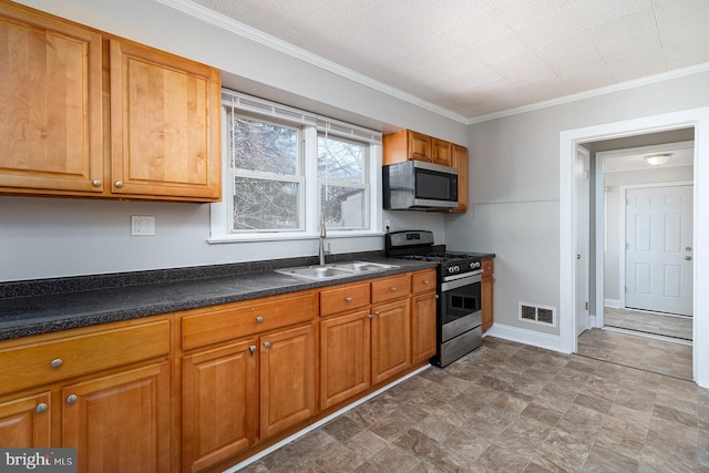 kitchen featuring brown cabinets, stainless steel appliances, visible vents, ornamental molding, and a sink