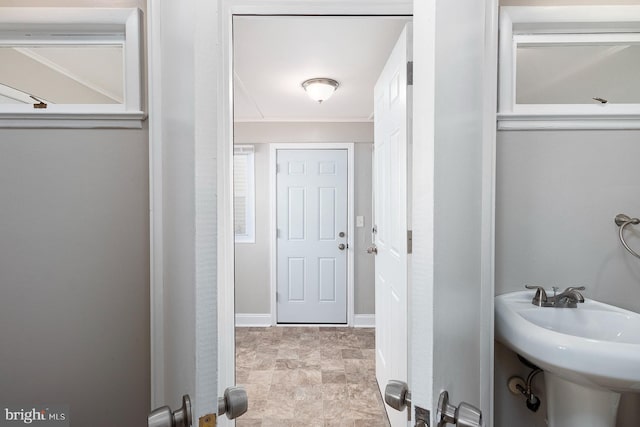 bathroom with baseboards and a sink