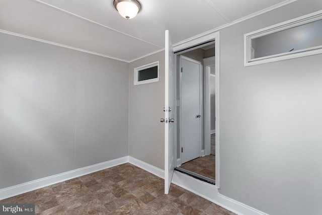 interior space with crown molding and baseboards