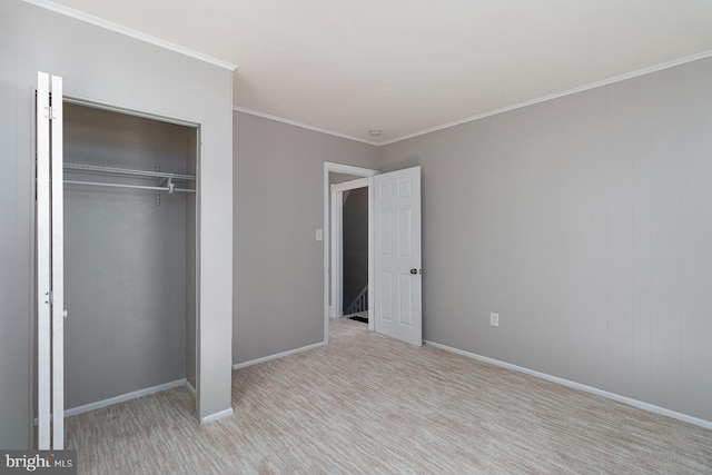 unfurnished bedroom featuring baseboards, a closet, and ornamental molding