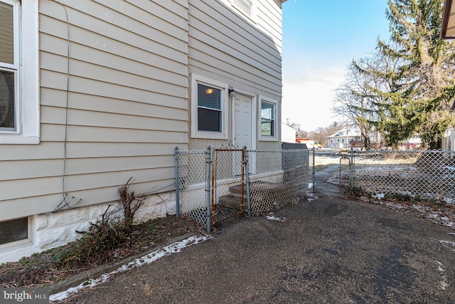view of property exterior with fence and a gate