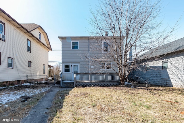 back of house featuring a yard and a deck