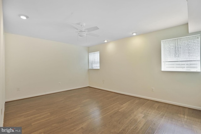 spare room featuring ceiling fan, wood finished floors, baseboards, and recessed lighting