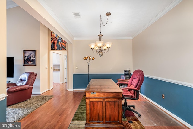 office space with a chandelier, wood finished floors, crown molding, and baseboards