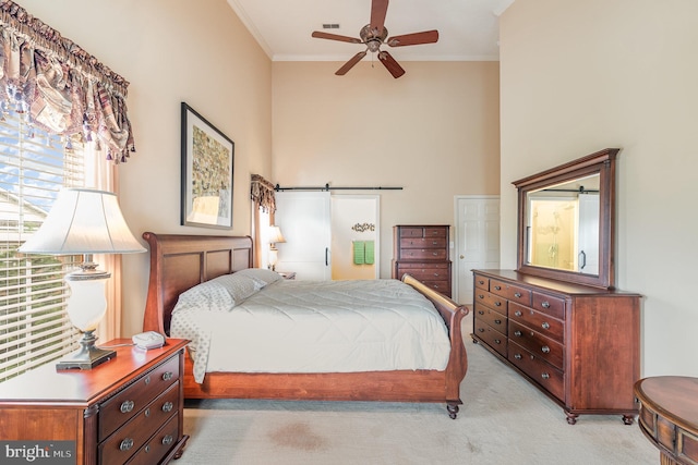 bedroom with light colored carpet, ornamental molding, a towering ceiling, and a ceiling fan