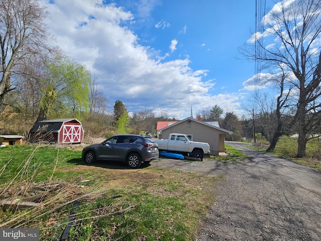 exterior space with an outbuilding and a storage shed