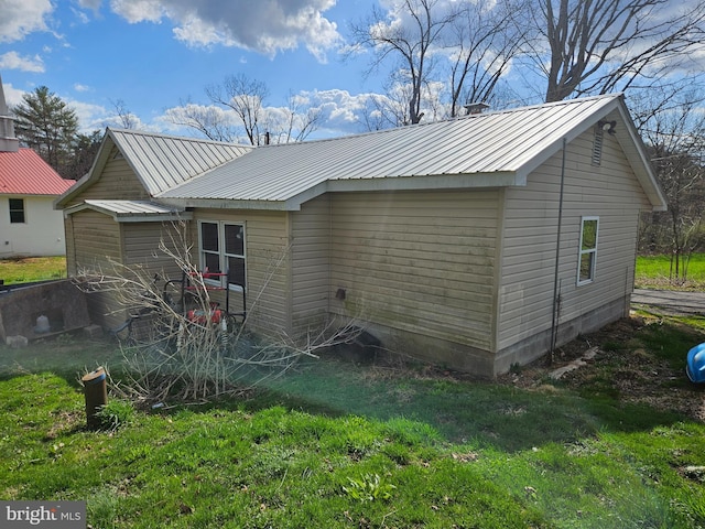 back of house featuring metal roof