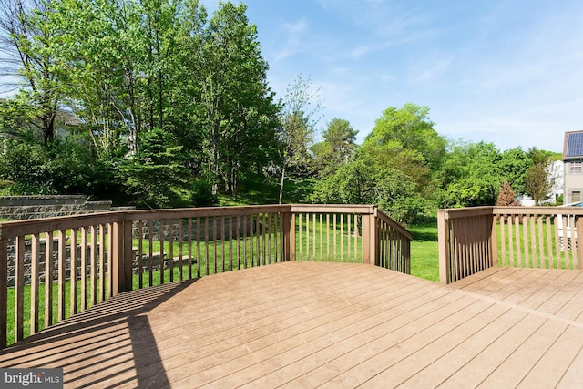 wooden terrace with a lawn