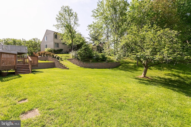 view of yard featuring a wooden deck and stairway