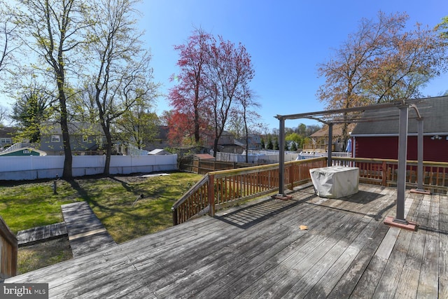 wooden terrace featuring a lawn, a fenced backyard, and a residential view