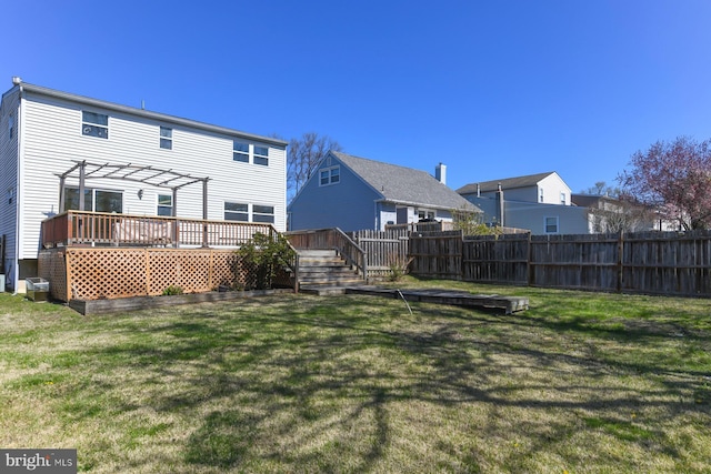 back of house featuring a lawn, a wooden deck, a pergola, and fence