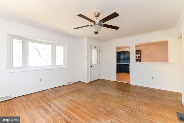 unfurnished living room with wood-type flooring, crown molding, and visible vents