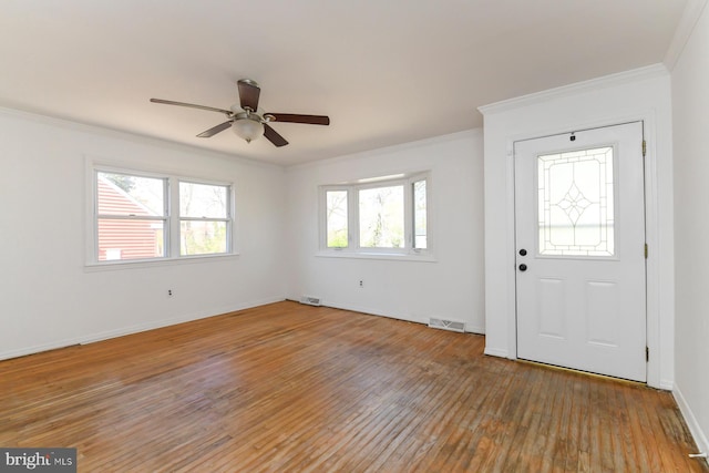 entryway with ceiling fan, baseboards, ornamental molding, and light wood-type flooring