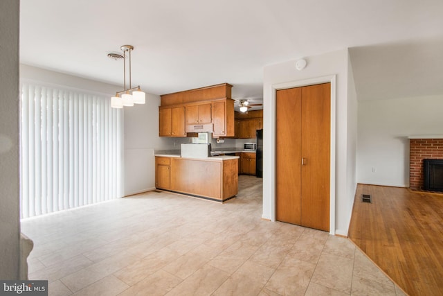 7906 Longmeadow Dr, Frederick, MD 21701 - kitchen featuring brown cabinetry, open floor plan, stainless steel microwave, a peninsula, and range hood