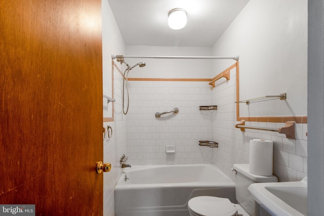 7906 Longmeadow Dr, Frederick, MD 21701 - bathroom with a sink, tile walls, a wainscoted wall, shower / tub combination, and toilet