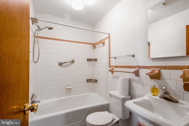 7906 Longmeadow Dr, Frederick, MD 21701 - full bathroom featuring toilet, washtub / shower combination, a sink, and tile walls