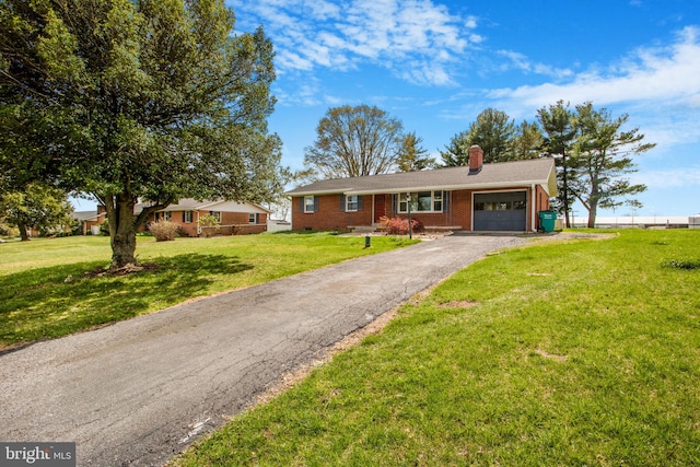 7906 Longmeadow Dr, Frederick, MD 21701 - ranch-style home with a chimney, aphalt driveway, an attached garage, a front yard, and brick siding