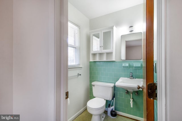 7906 Longmeadow Dr, Frederick, MD 21701 - bathroom with toilet, a wainscoted wall, and tile walls
