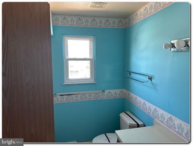 28 Lincoln Pl, Whitehall, PA 18052 - half bath with visible vents, toilet, and a wainscoted wall