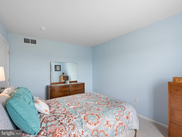 carpeted bedroom with baseboards and visible vents