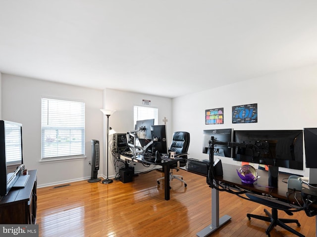 home office featuring baseboards, visible vents, and light wood-style flooring