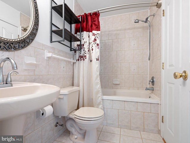 full bath featuring tiled shower / bath combo, tile walls, tile patterned floors, and toilet