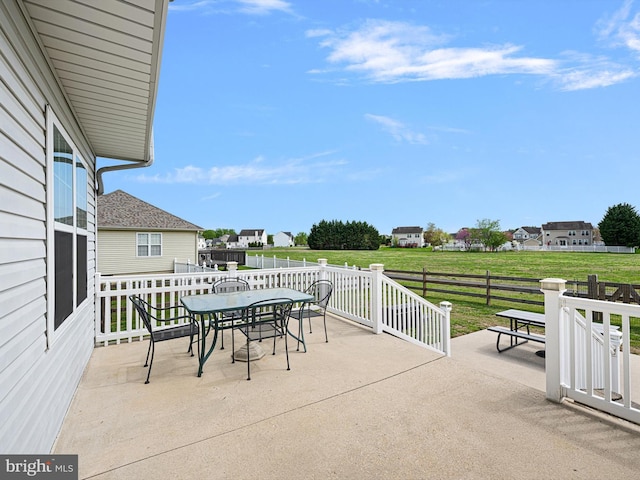 view of patio with fence and outdoor dining space