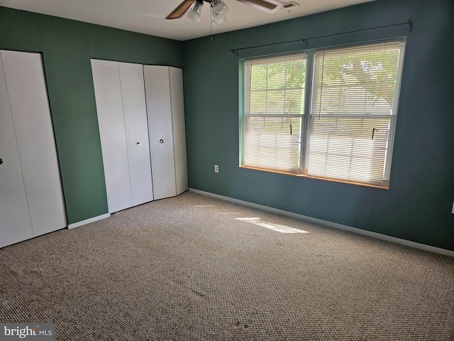 unfurnished bedroom featuring carpet flooring, baseboards, and ceiling fan