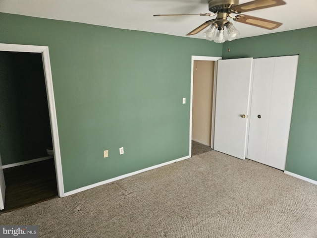 unfurnished bedroom featuring a ceiling fan, baseboards, carpet, and a closet