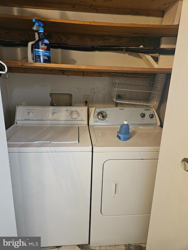 clothes washing area featuring washer and dryer and laundry area