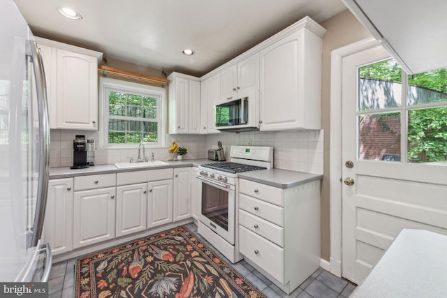 4260 25th St N, Arlington, VA 22207 - kitchen with refrigerator, a sink, white cabinetry, stainless steel microwave, and gas range gas stove