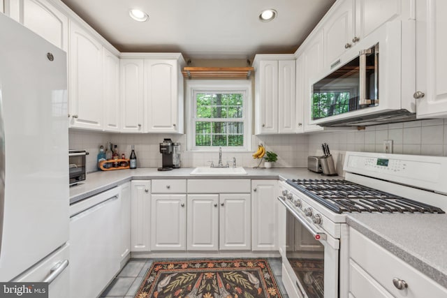 4260 25th St N, Arlington, VA 22207 - kitchen featuring a sink, white appliances, and white cabinetry